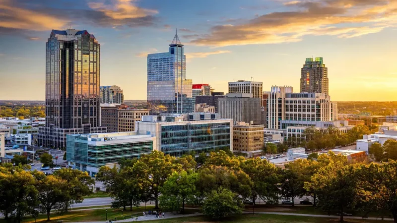 A modern downtown skyline in Raleigh, North Carolina, at golden hour in the 984 area code region.