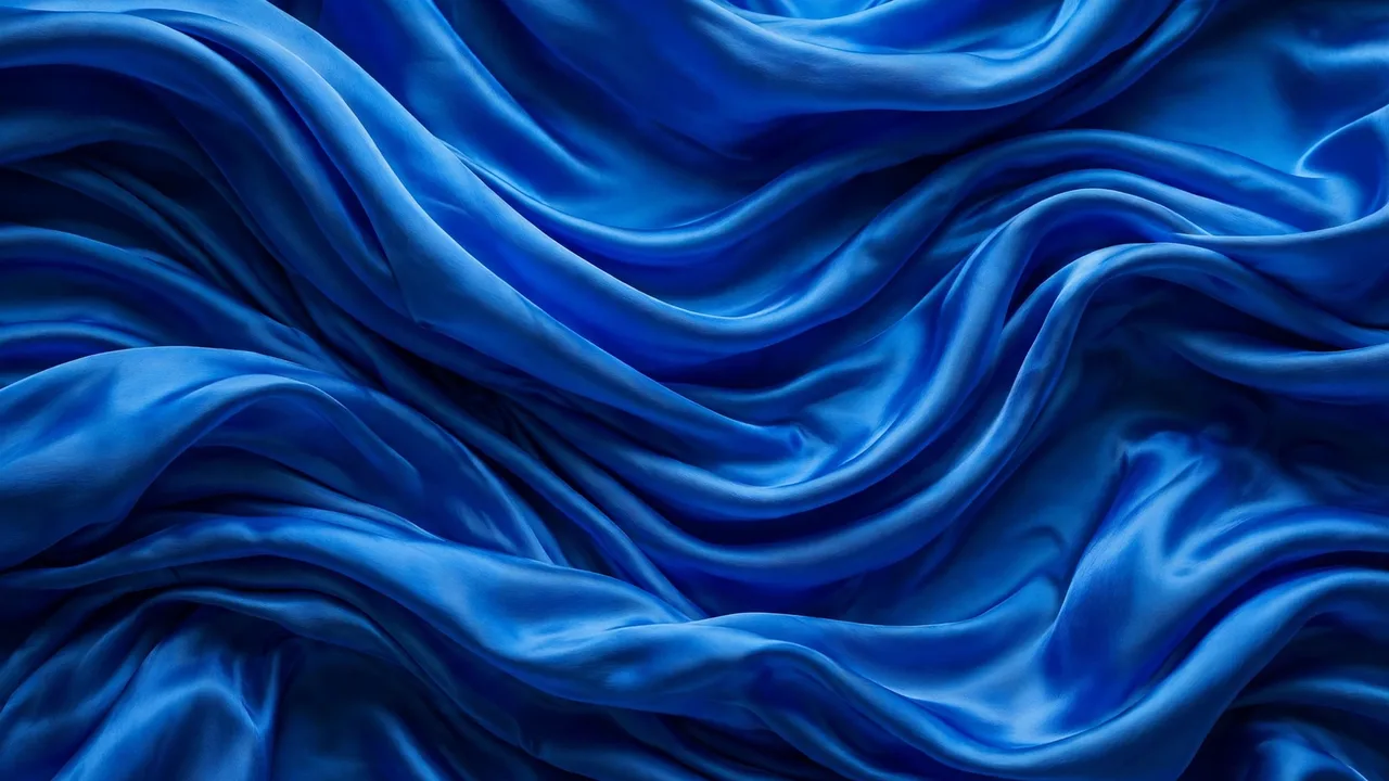 Flowing vivid cobalt blue silk fabric waves in rich saturated tones